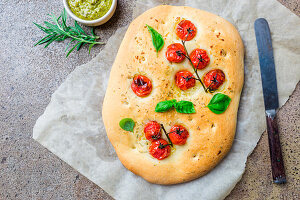Traditional Italian Focaccia with tomatoes and rosemary