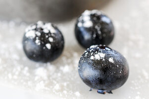 A close-up of blueberries with powdered sugar