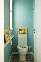 Children's drawings on blue walls in toilet