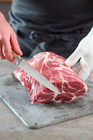 Pork collar being cut