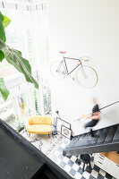 View from gallery down staircase into bright living space