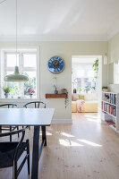 Pale wooden flooring in light-flooded dining room