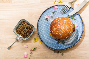 A mealworm burger – a bun with a veggie patty and worms