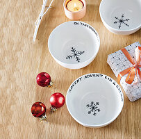 Bowls painted with Christmas words and snowflakes