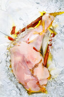 Vacuum-packed chicken leg with spices in water