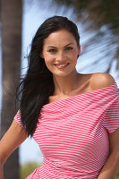 A young brunette woman wearing a red-and-white striped top