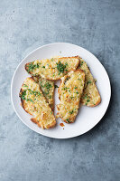 Grilled bread with herb butter and cheese