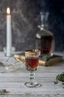 Herbal liqueur in a glass with a golden rim