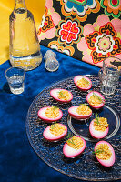 Russian eggs, garnished with dill on a glass plate, served with vodka