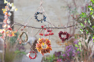 Mobile with wreaths of leaves, sloes, rose hips, crab apples and grass