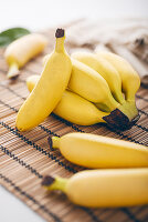 Mini bananas on a bamboo mat