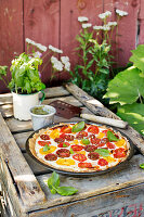 A colourful tomato tart on a rustic wooden crate
