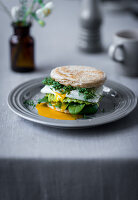A English muffins with a poached egg, avocado, spinach and cress for an Easter breakfast