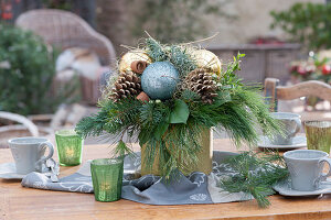 Christmas bouquet in golden vase as table decoration