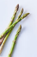 Green asparagus spears on a white surface
