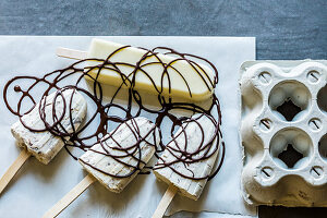 Ice cream sticks with chocolate spiral decorations