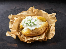 A baked potato with tzatziki