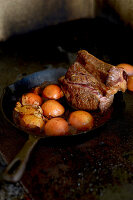 Beef with onions in a cast-iron pan