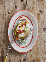 A jacket potato with grilled salmon and sour cream