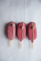 Three red ice cream sticks