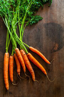 Fresh carrots on wooden background