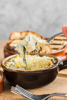 Artichoke and spinach dip served with toasted bread