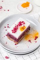 A slice of raspberry panna cotta cake with turmeric