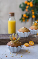 Muffins with physalis in porcelain dishes