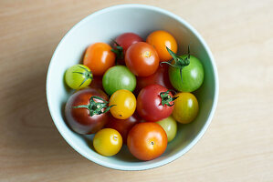 Colourful tomatoes in small bowls