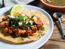 Tempeh taco on corn tortilla with pineapple, clinatro and onion