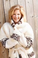 A blonde woman wearing a knitted Norwegian cardigan