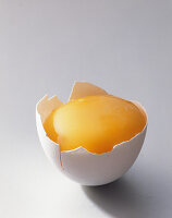 Raw yolk in an egg shell (close-up)