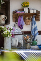 Flea-market crockery and kitchen utensils in vintage outdoor kitchen
