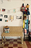 Woven bench in the hallway with checkerboard floor and ladder as a shelf