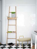 Ladder with shelf on the wall on checkered floor