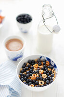 A bowl of cereal loops with a good amount of European blueberries