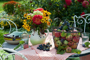 Autumn bouquet of dahlias, Helenium, black-eyed Susan, coneflower, hydrangea and fruit bunches from wild wine