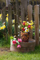 Colourful spring flowers and flower bulbs in glass vase