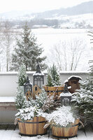 Planted half-barrels on balcony with view of snowy landscape