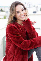 A young woman wearing a red coat