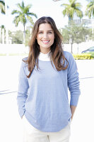 A young woman wearing a lilac jumper