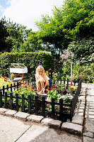 Girls in the fenced mini-garden