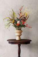 Bouquet of dried flowers on little old wooden table