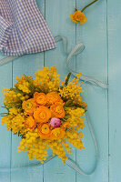 Small arrangement of mimosa and ranunculus