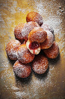 A stack of mini jam doughnuts with icing sugar
