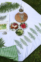 Snacks on handmade picnic blanket with fern motifs