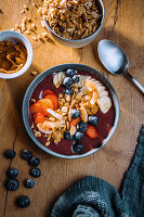 Vegan acai bowl with coconut chips and fresh fruit