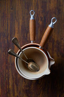 Stacked saucepans with silver spoons