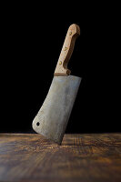 A cleaver on a wooden background
