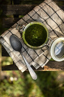 Wild garlic pesto in a jar on a tea towel